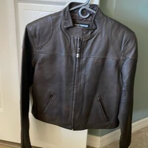 Waist length women’s brown Italian leather jacket. Zipper closure.